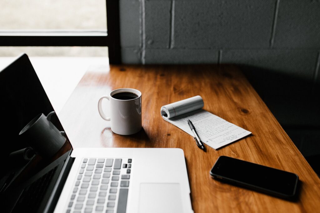 coffee cup and laptop and notes